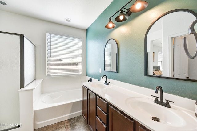 bathroom with vanity, tile patterned floors, and a bath