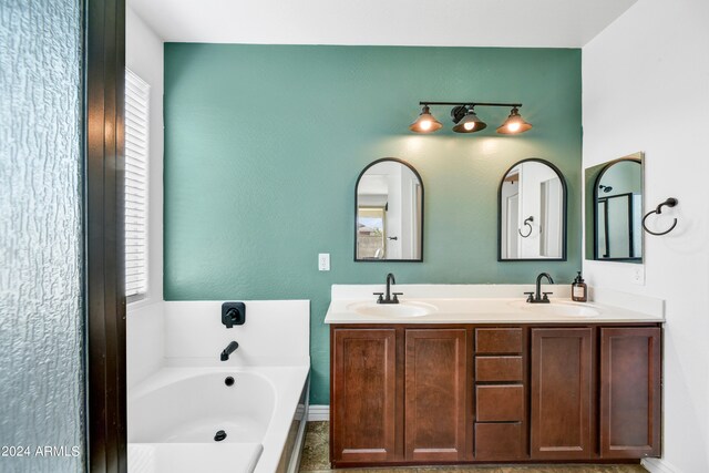 bathroom featuring vanity and a bath