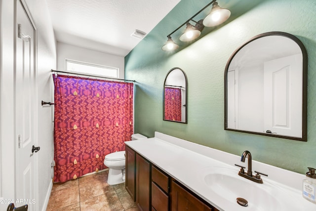 bathroom featuring a textured ceiling, toilet, vanity, curtained shower, and tile patterned floors