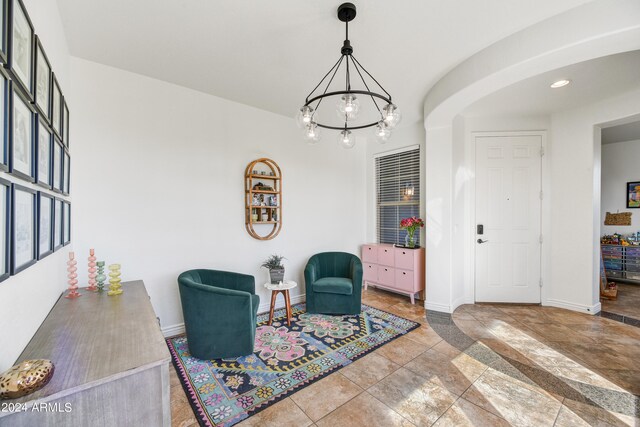 living area featuring a chandelier