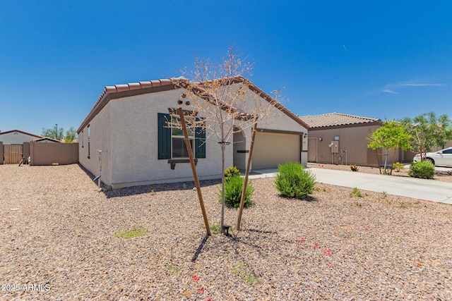 25539 W Gwen St, Buckeye, AZ 85326 - view of front of house with a tile roof, stucco siding, driveway, and a garage