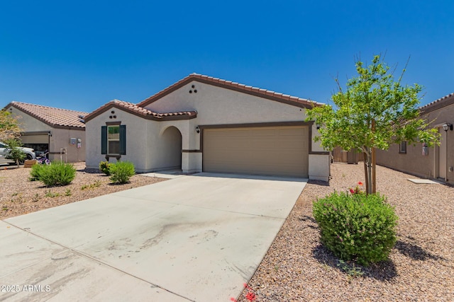 25539 W Gwen St, Buckeye, AZ 85326 - mediterranean / spanish house with stucco siding, a tiled roof, a garage, and concrete driveway