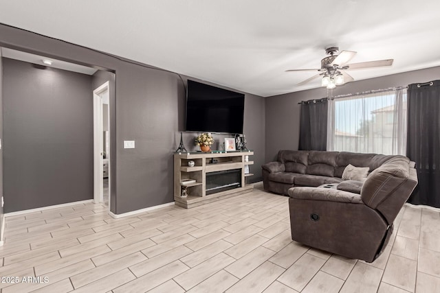 25539 W Gwen St, Buckeye, AZ 85326 - living room with ceiling fan, light wood-type flooring, and baseboards