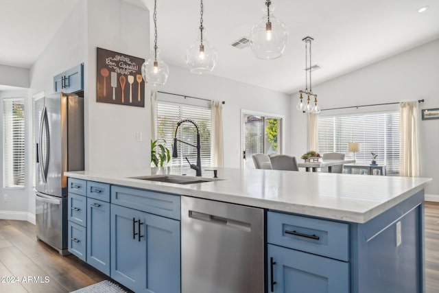 kitchen with dark wood-type flooring, lofted ceiling, hanging light fixtures, and stainless steel appliances