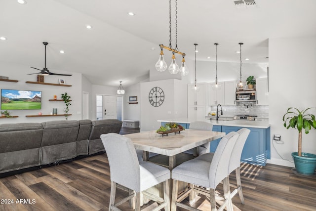 dining room with dark hardwood / wood-style flooring, sink, and ceiling fan