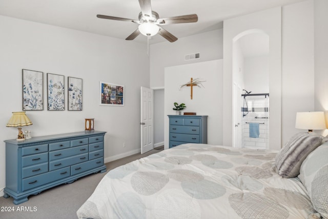 carpeted bedroom with connected bathroom and ceiling fan