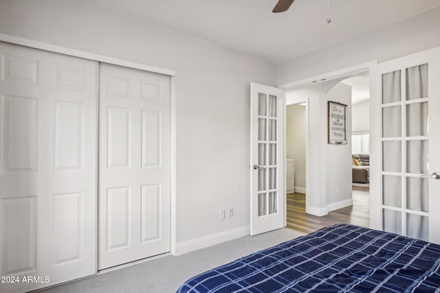 unfurnished bedroom with a closet, hardwood / wood-style floors, ceiling fan, and french doors