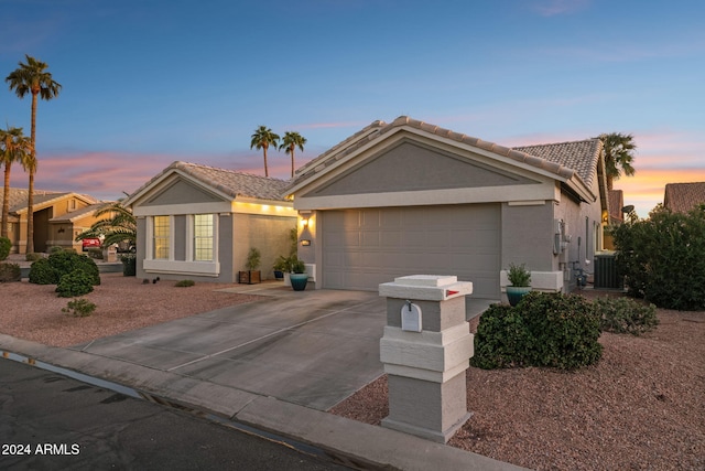 ranch-style home with a garage and cooling unit