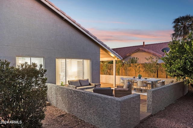 patio terrace at dusk with an outdoor living space