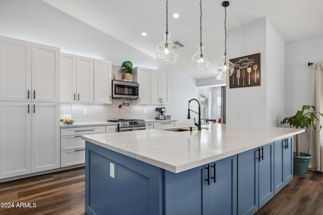 kitchen featuring stainless steel appliances, dark wood-type flooring, light stone counters, pendant lighting, and white cabinetry