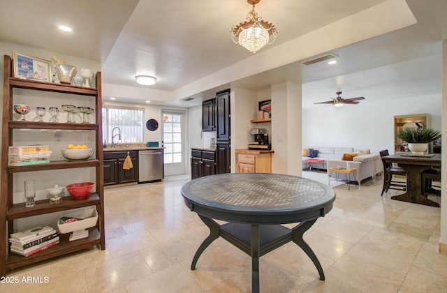 dining room featuring sink, ceiling fan with notable chandelier, and light tile patterned floors