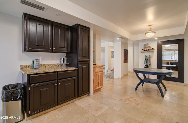 kitchen with pendant lighting and dark brown cabinets