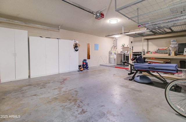 garage with a garage door opener, electric water heater, and washer and clothes dryer