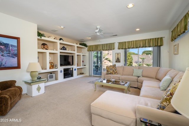 living room with carpet floors and ceiling fan