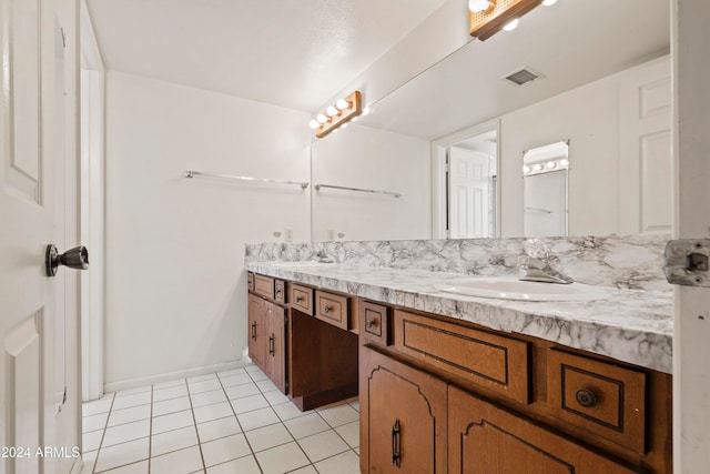 bathroom featuring tile patterned flooring and vanity