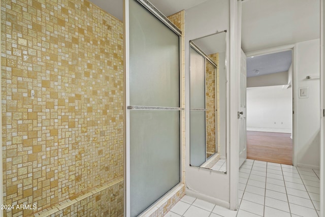 bathroom featuring tile patterned flooring and a shower with shower door