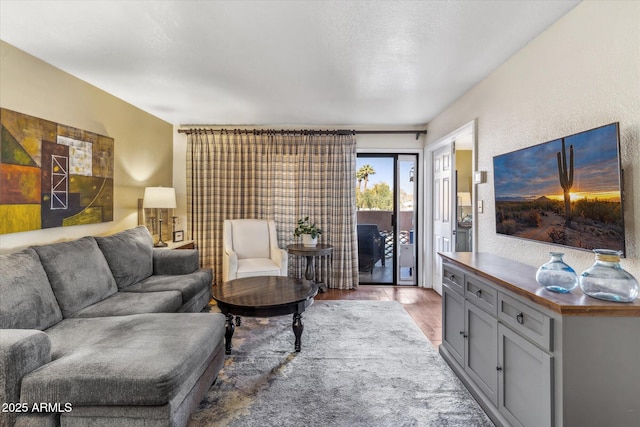 living room featuring light hardwood / wood-style flooring and a textured ceiling