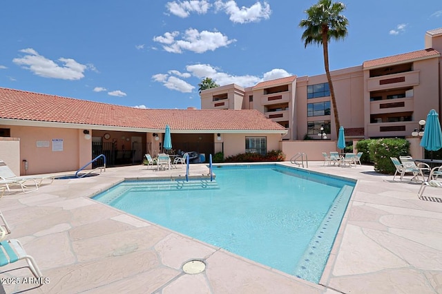 view of swimming pool with a patio area