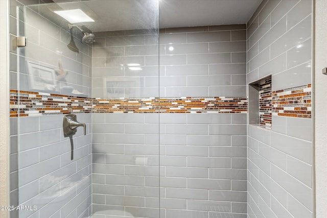 bathroom with tiled shower