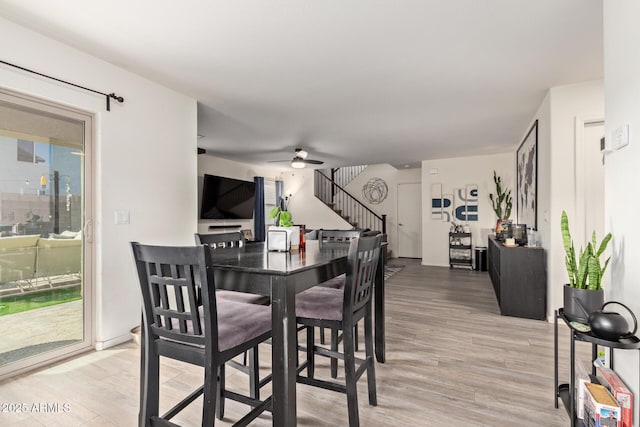 dining area featuring hardwood / wood-style flooring and ceiling fan