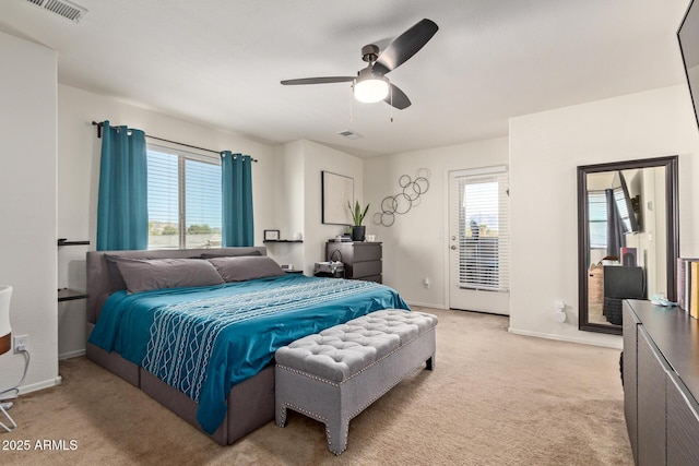 carpeted bedroom featuring multiple windows and ceiling fan