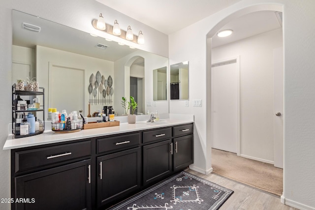 bathroom with vanity and hardwood / wood-style flooring