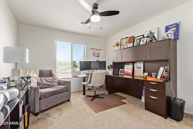 home office with ceiling fan and light carpet