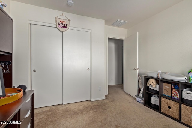 bedroom with light carpet and a closet