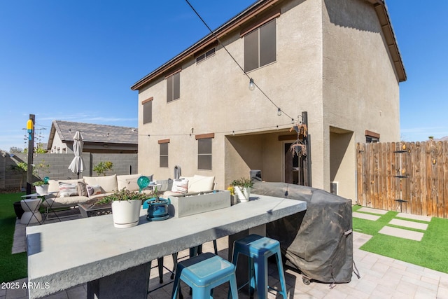 back of property featuring an outdoor hangout area, an outdoor bar, and a patio