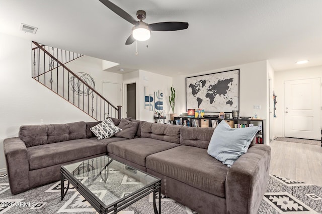 living room with ceiling fan and light hardwood / wood-style flooring