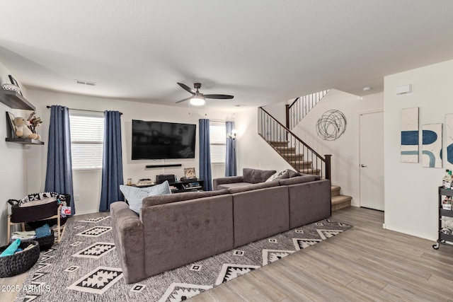 living room with hardwood / wood-style floors and ceiling fan