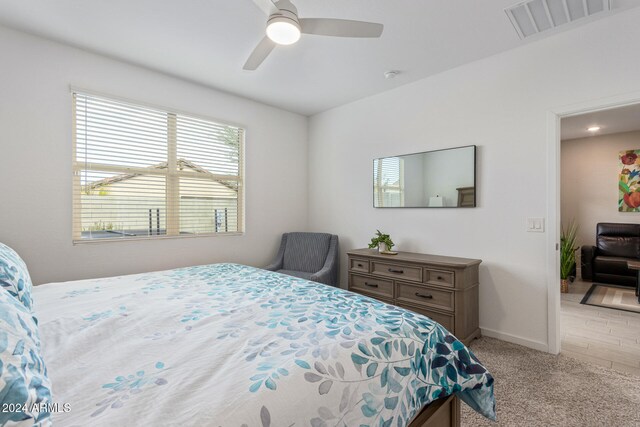 bedroom with ceiling fan and light hardwood / wood-style flooring