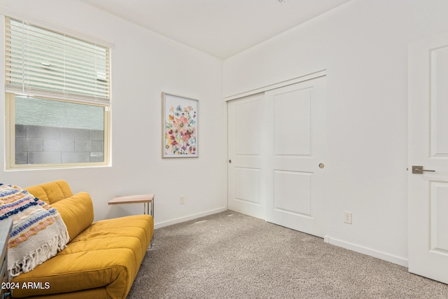 living area featuring light carpet