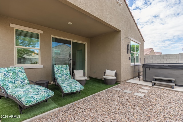 view of patio / terrace with a hot tub