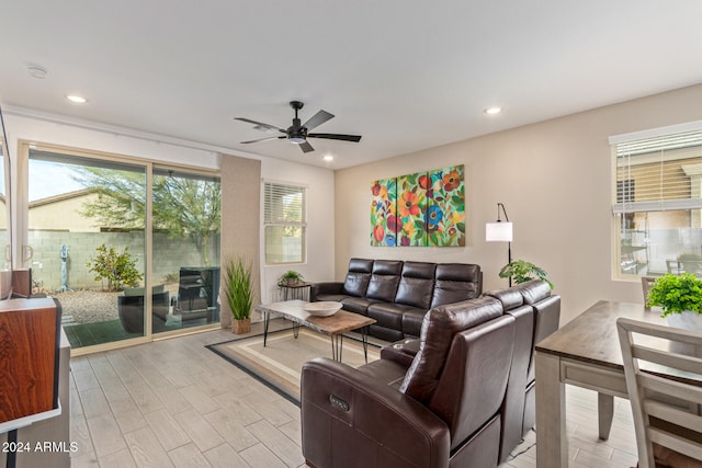 living room featuring ceiling fan and light hardwood / wood-style flooring