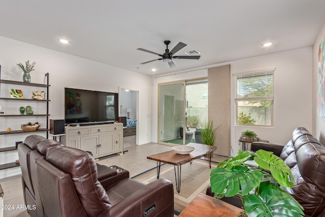 living room with light wood-type flooring and ceiling fan