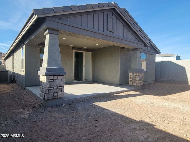 rear view of property featuring central AC and a patio area