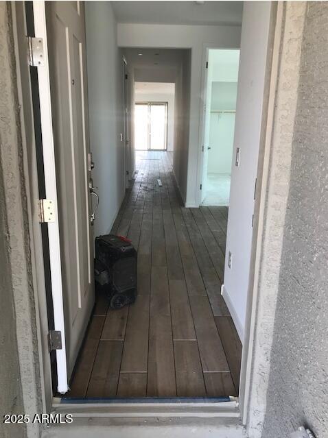 hallway with dark hardwood / wood-style flooring