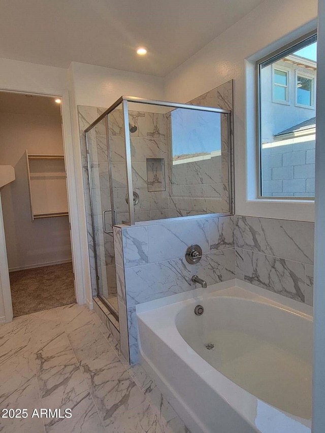 bathroom featuring separate shower and tub