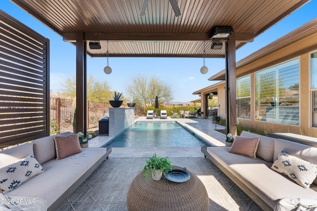 view of pool with a patio, an outdoor living space, ceiling fan, and pool water feature