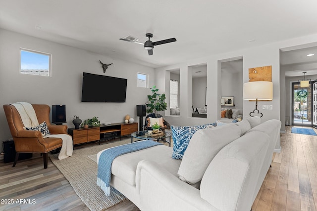 living room with hardwood / wood-style floors and ceiling fan