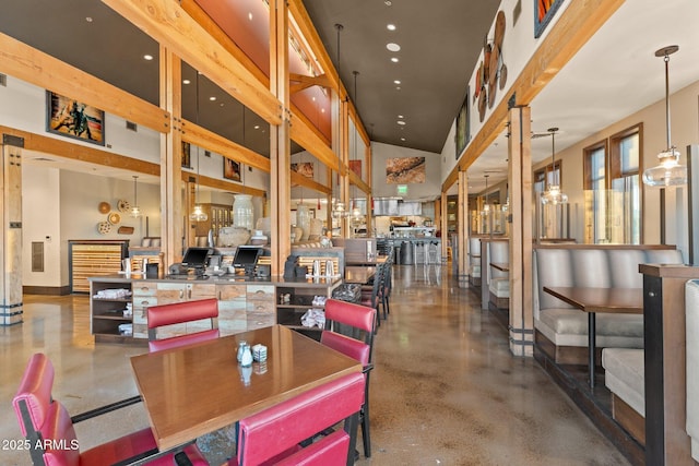 dining area featuring a towering ceiling