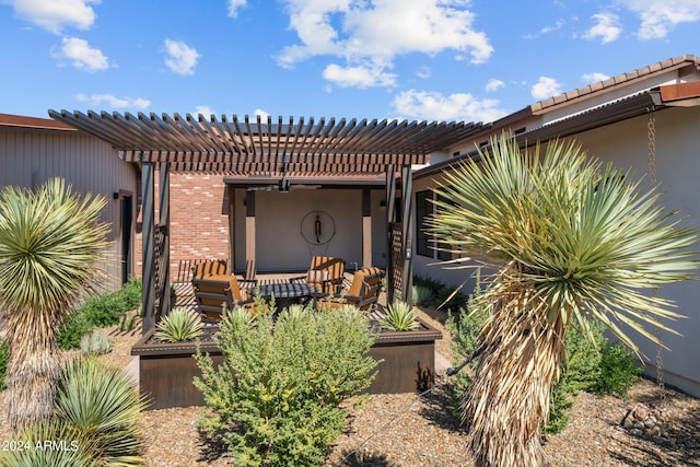 property entrance featuring a patio area and a pergola