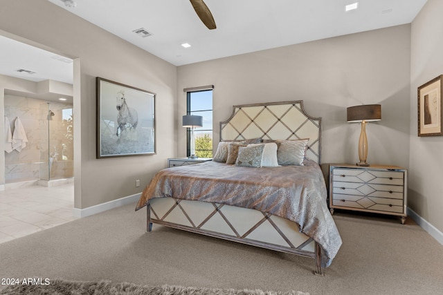 carpeted bedroom with ensuite bath and ceiling fan