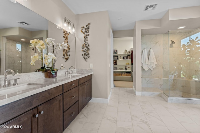 bathroom with vanity and tiled shower