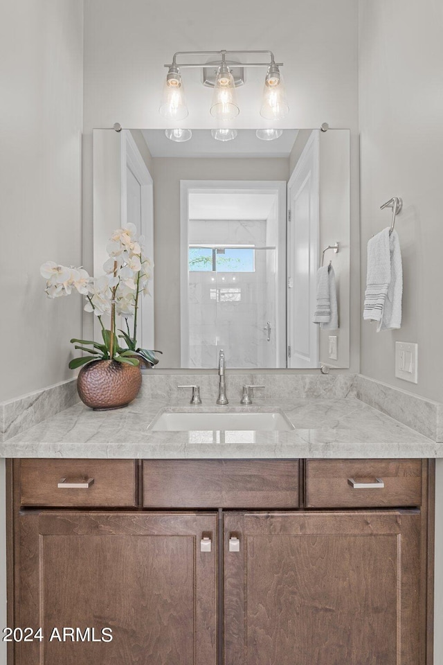 bathroom with a shower and vanity