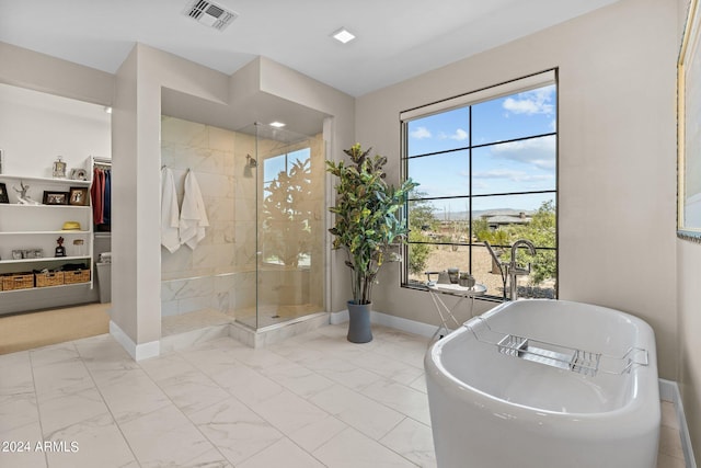 bathroom with shower with separate bathtub