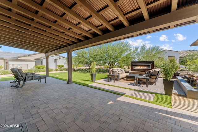 view of patio / terrace with an outdoor living space with a fireplace