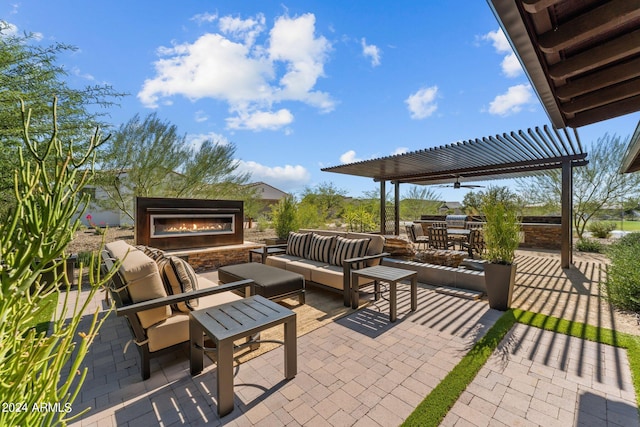 view of patio / terrace featuring an outdoor living space with a fireplace and a pergola