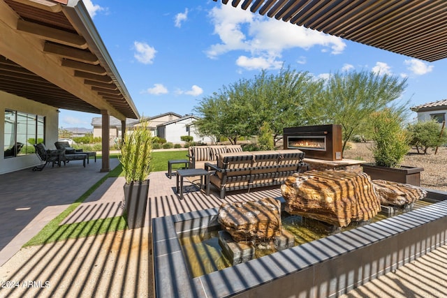 view of patio / terrace with an outdoor living space with a fireplace